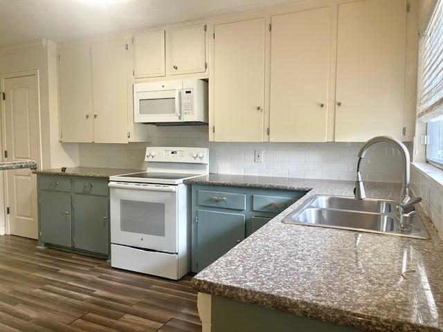 kitchen with sink, dark wood-type flooring, white cabinets, white appliances, and decorative backsplash