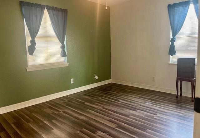 spare room featuring dark wood-type flooring