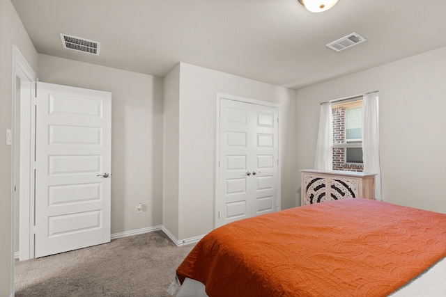 bedroom featuring light colored carpet and a closet