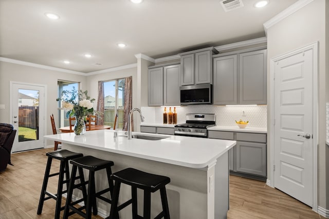 kitchen with sink, gray cabinets, and stainless steel appliances