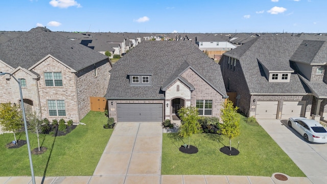 french country home with a garage and a front yard