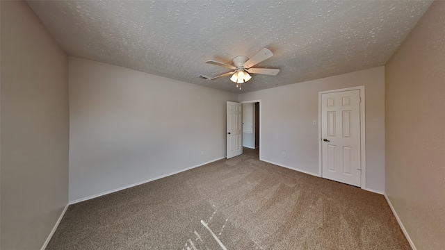 unfurnished bedroom with a closet, ceiling fan, carpet, and a textured ceiling