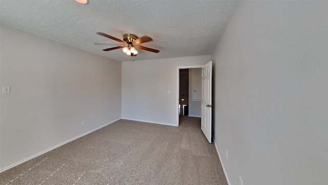 carpeted empty room featuring a textured ceiling and ceiling fan