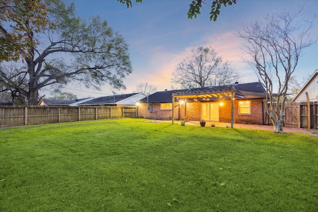 yard at dusk featuring a pergola