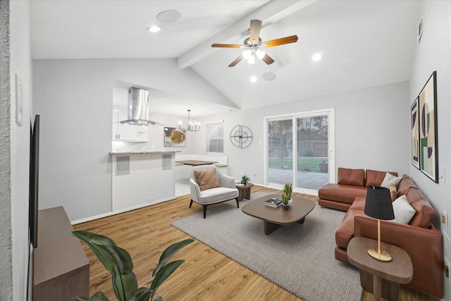 living room with hardwood / wood-style floors, ceiling fan with notable chandelier, and vaulted ceiling with beams