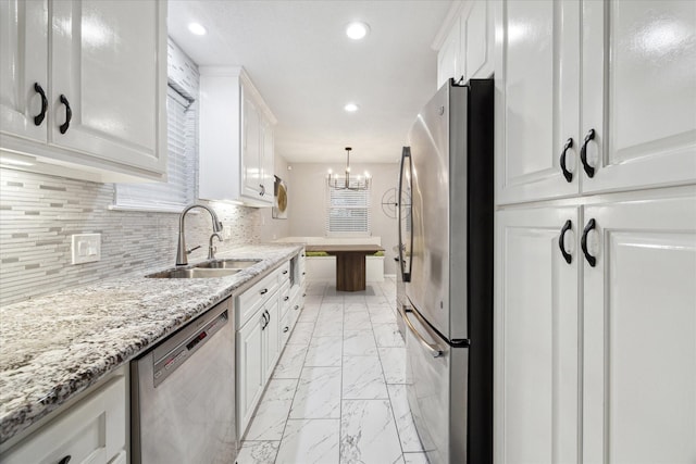 kitchen with sink, stainless steel appliances, and white cabinetry