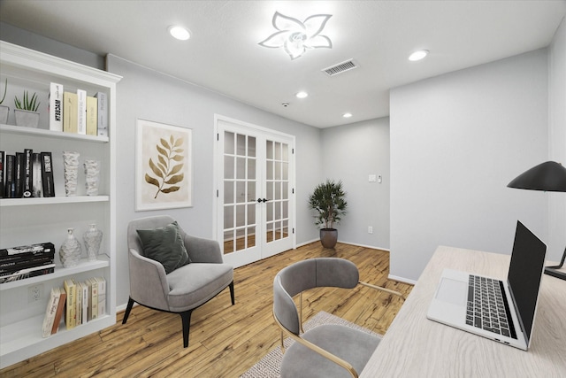 office featuring hardwood / wood-style flooring, french doors, and built in shelves