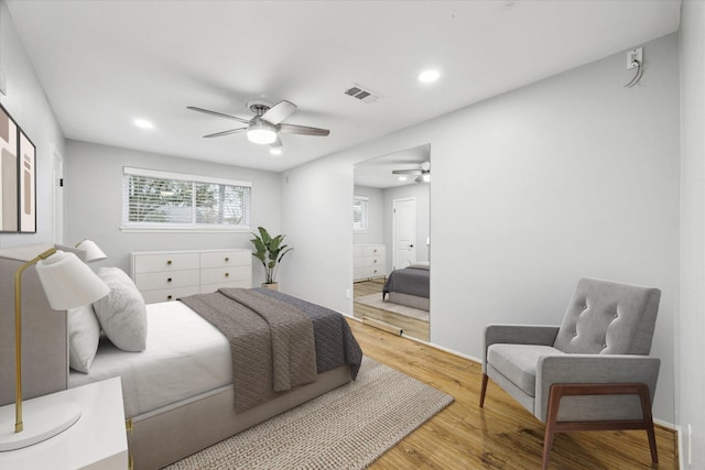 bedroom with hardwood / wood-style floors and ceiling fan