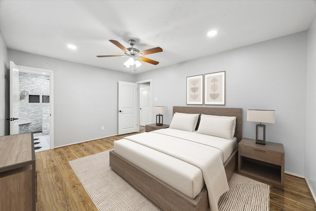 bedroom featuring wood-type flooring, connected bathroom, and ceiling fan