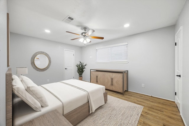 bedroom with ceiling fan and light hardwood / wood-style floors