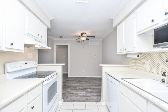 kitchen with white appliances, white cabinets, sink, ornamental molding, and ceiling fan