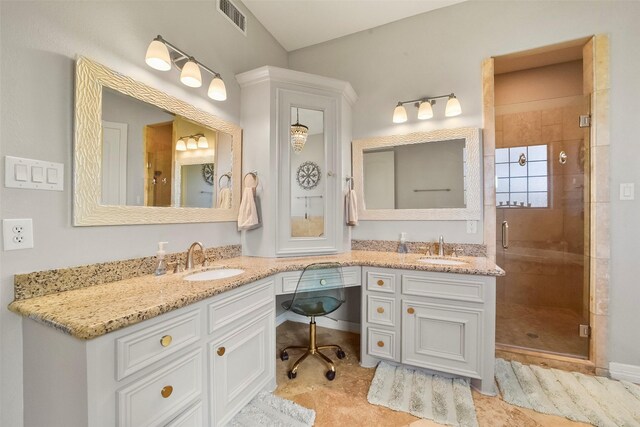 bathroom featuring an enclosed shower, tile patterned floors, and vanity