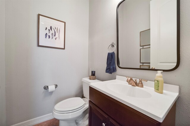 bathroom with toilet and vanity