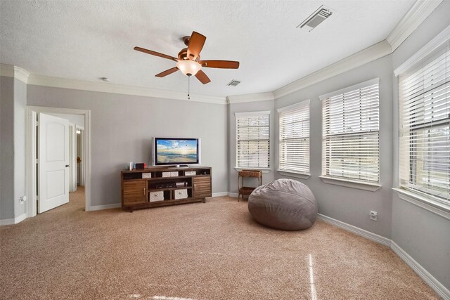 living area with crown molding, a healthy amount of sunlight, a textured ceiling, and ceiling fan