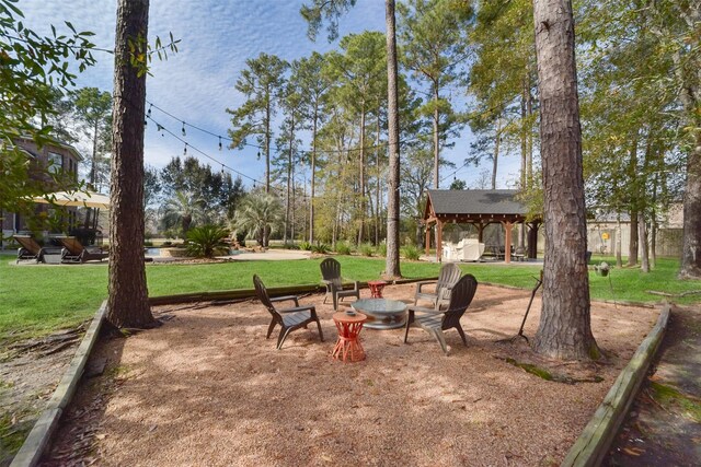 view of yard with an outdoor fire pit and a gazebo