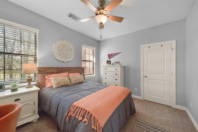 bedroom featuring ceiling fan and carpet