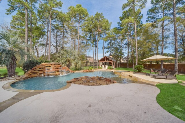 view of swimming pool with a patio, a gazebo, pool water feature, and a hot tub