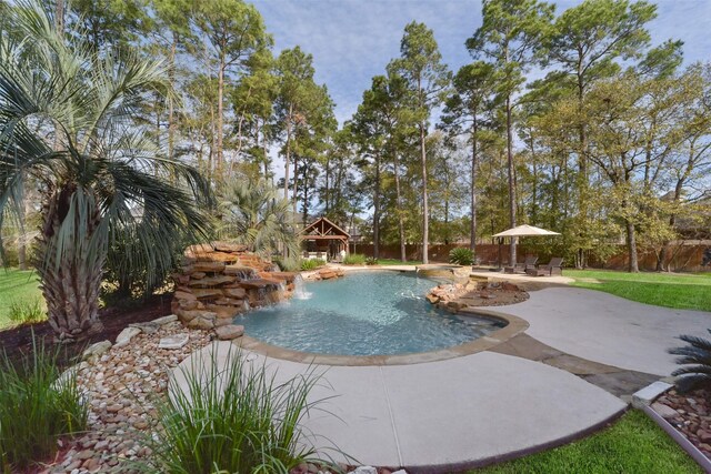 view of pool with pool water feature, a gazebo, and a patio