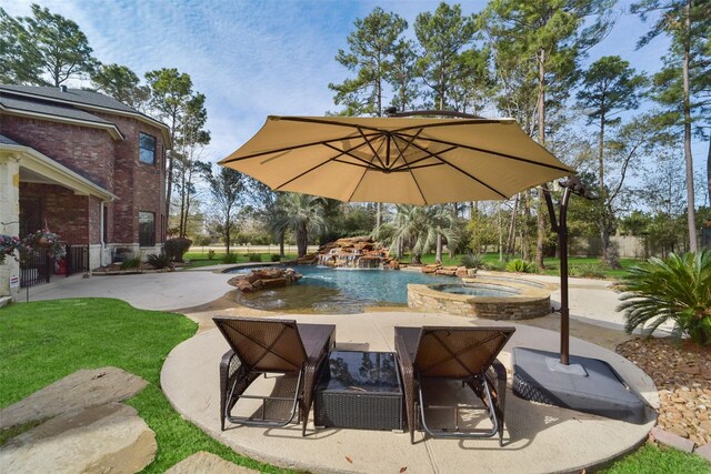 view of swimming pool featuring an in ground hot tub and a patio area