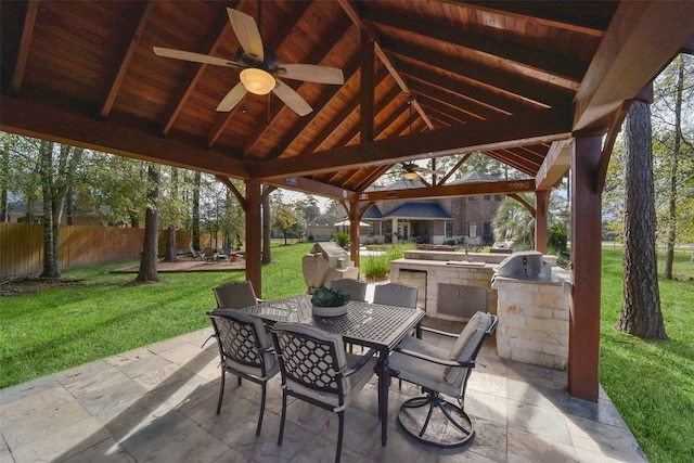 view of patio / terrace with ceiling fan, a gazebo, an outdoor kitchen, and a grill