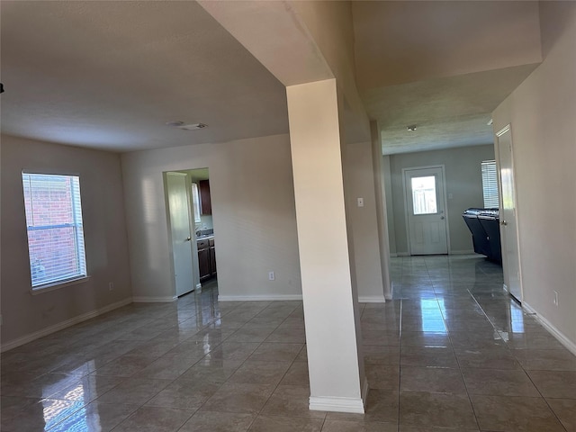 spare room with tile patterned flooring and a healthy amount of sunlight