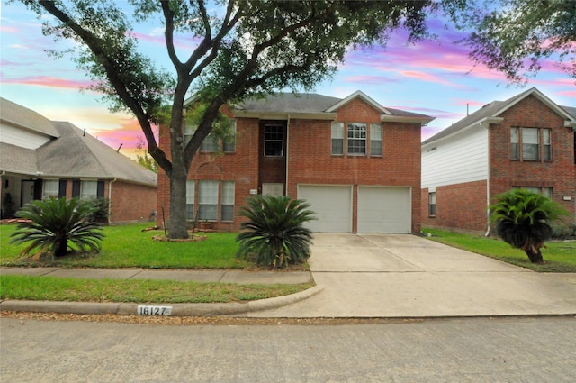 view of front facade with a garage, brick siding, concrete driveway, and a lawn