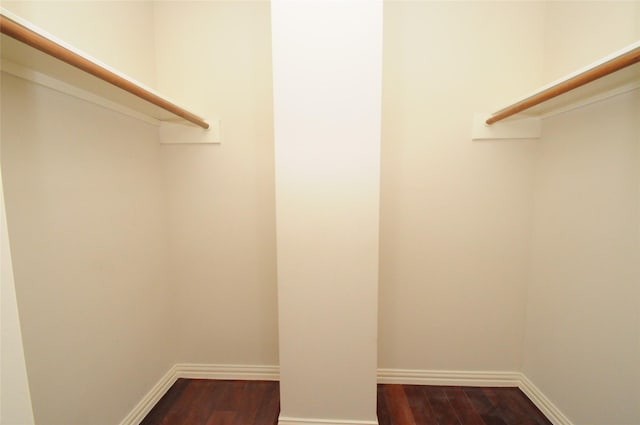 spacious closet with dark wood-style floors