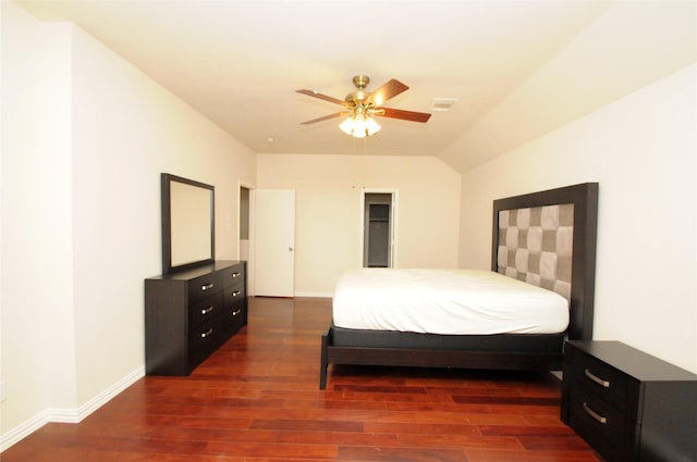 bedroom featuring a ceiling fan, visible vents, wood finished floors, and baseboards