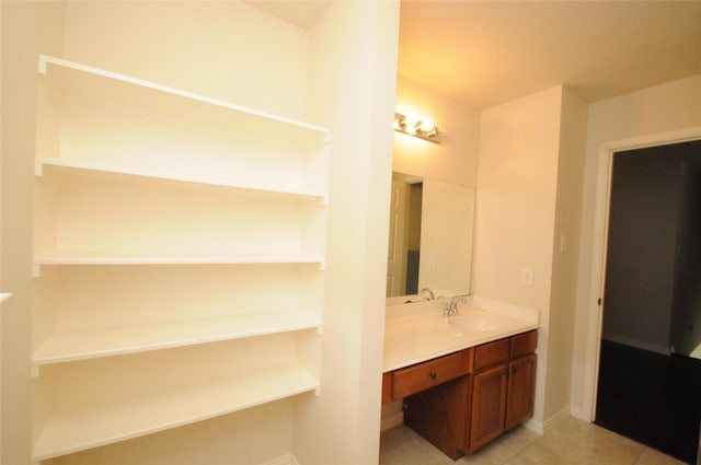 bathroom featuring tile patterned flooring, vanity, and baseboards