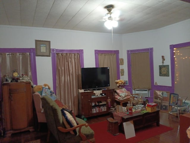 living room with wood-type flooring, crown molding, and a wall mounted air conditioner