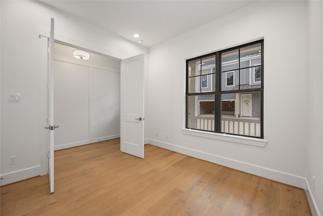 unfurnished bedroom featuring light hardwood / wood-style floors and a closet