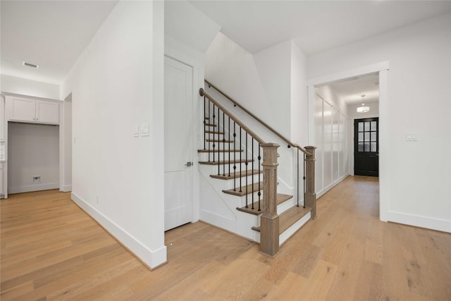 staircase with hardwood / wood-style flooring