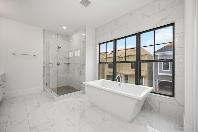 bathroom with shower with separate bathtub