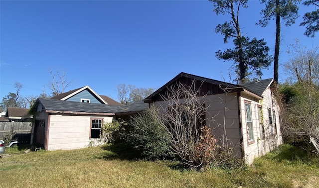 view of home's exterior with a lawn