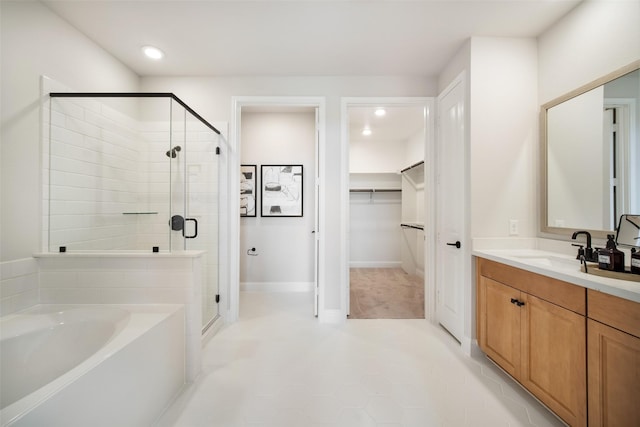 bathroom with vanity, independent shower and bath, and tile patterned flooring