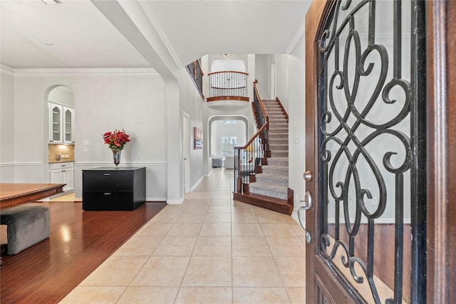 tiled entrance foyer with ornamental molding