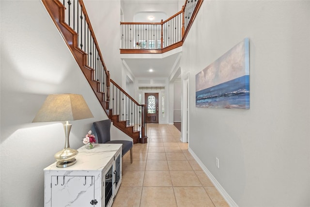 tiled entryway with a high ceiling