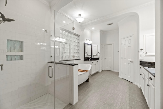 bathroom featuring crown molding, separate shower and tub, and vanity