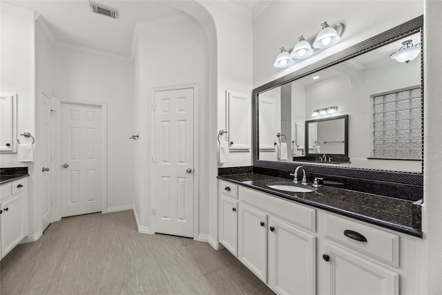 bathroom featuring ornamental molding and vanity