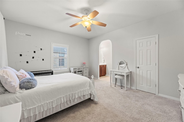 carpeted bedroom with ceiling fan and connected bathroom