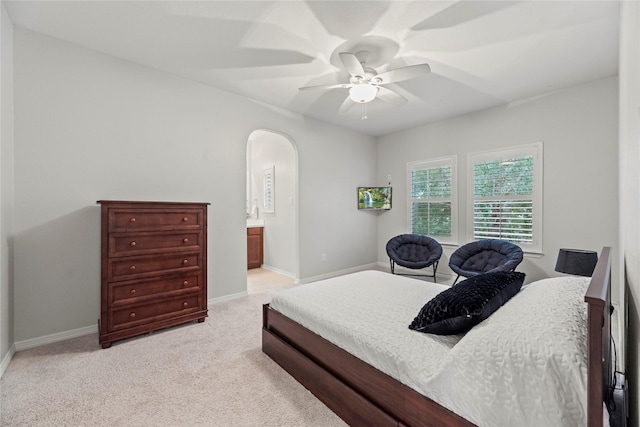 carpeted bedroom featuring ceiling fan and ensuite bathroom