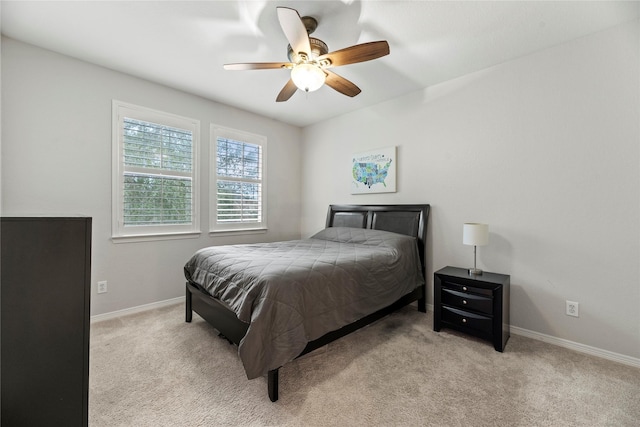 bedroom with ceiling fan and light colored carpet