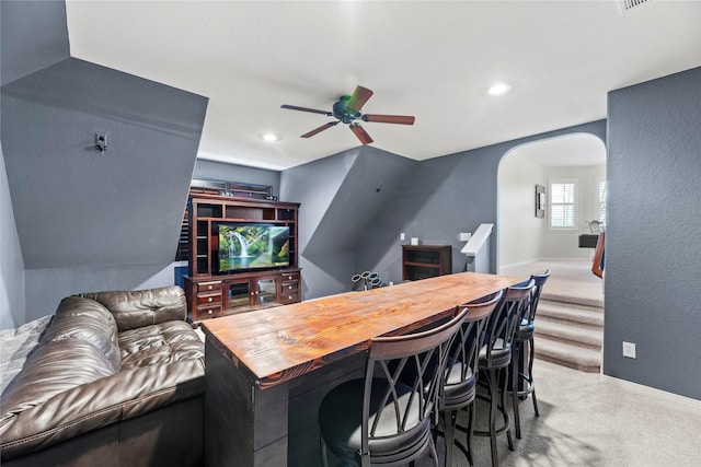 interior space featuring ceiling fan, light colored carpet, and butcher block countertops