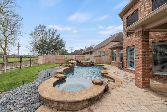 view of pool with pool water feature, an in ground hot tub, and a patio