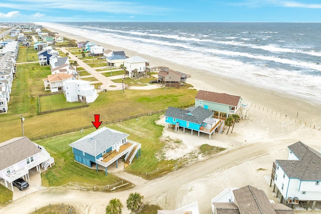 bird's eye view with a water view and a beach view