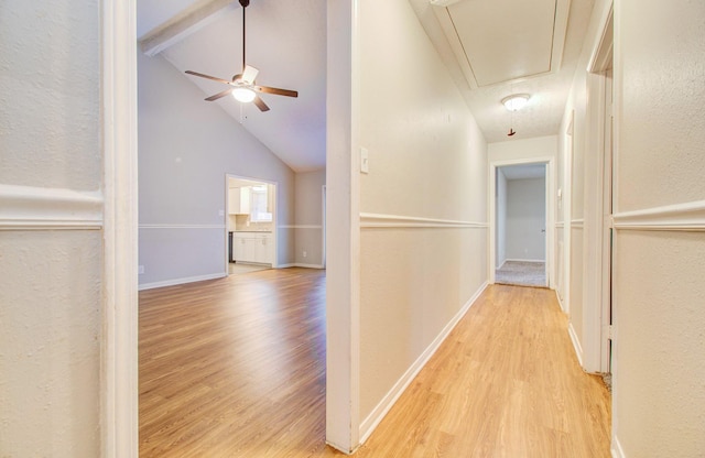 corridor featuring lofted ceiling with beams and light hardwood / wood-style floors