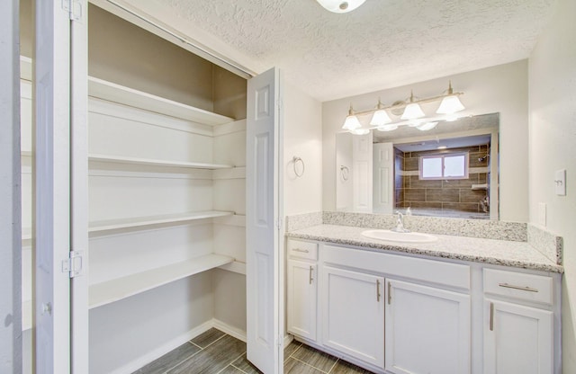 bathroom featuring vanity and a textured ceiling