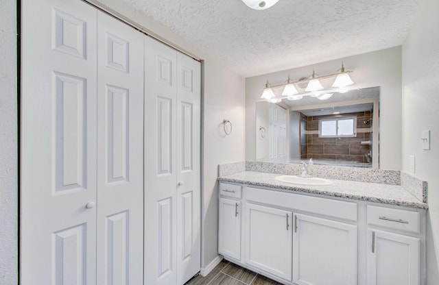 bathroom with vanity and a textured ceiling