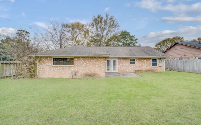 rear view of house featuring a patio and a yard