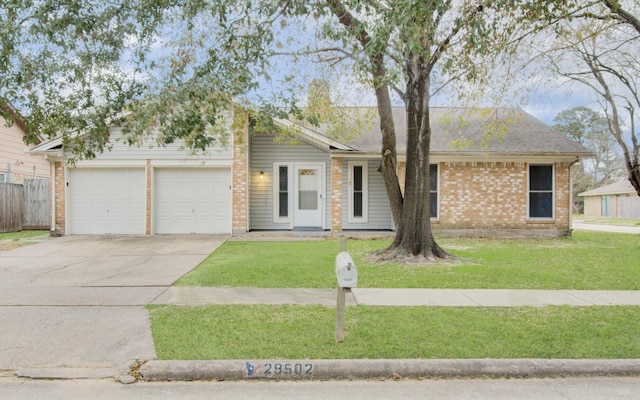 ranch-style home featuring a garage and a front lawn